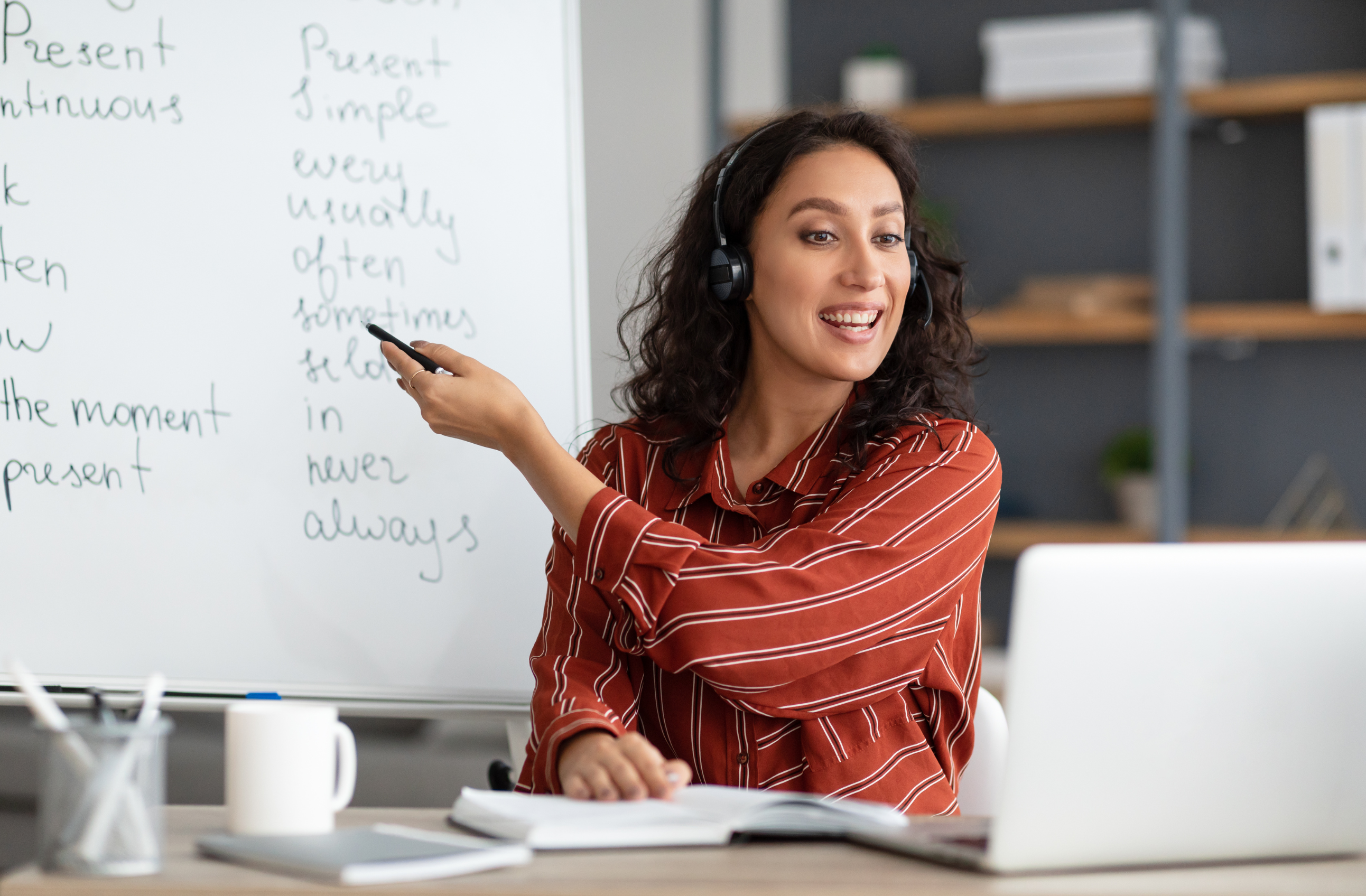 a glass board with various graphics and hand holding pen towards it
