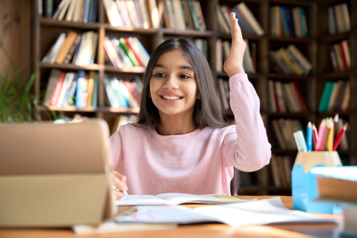 pair of glasses sitting on a row of books